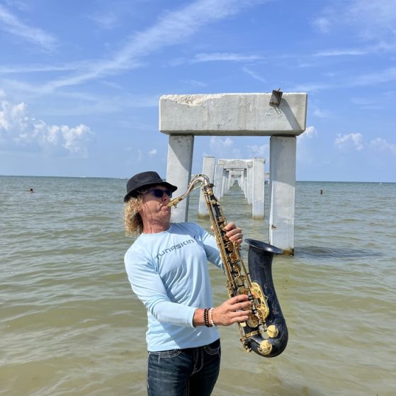 MattyB playing saxophone for a crowd at an outdoor public show in Southwest Florida