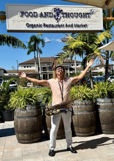 MattyB playing saxophone for a crowd at an outdoor public show in Southwest Florida
