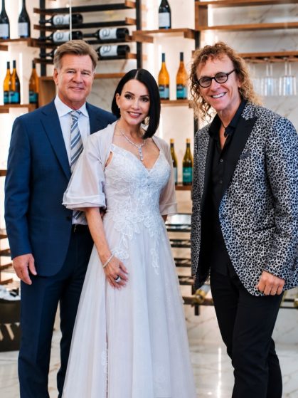 MattyB Entertainment saxophonist posing with elegantly dressed guests at a Southwest Florida wedding celebration
