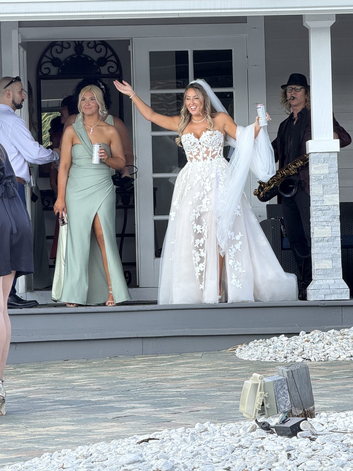 Matty B playing saxophone as the bride steps out of the island house at Grace River Island Resort